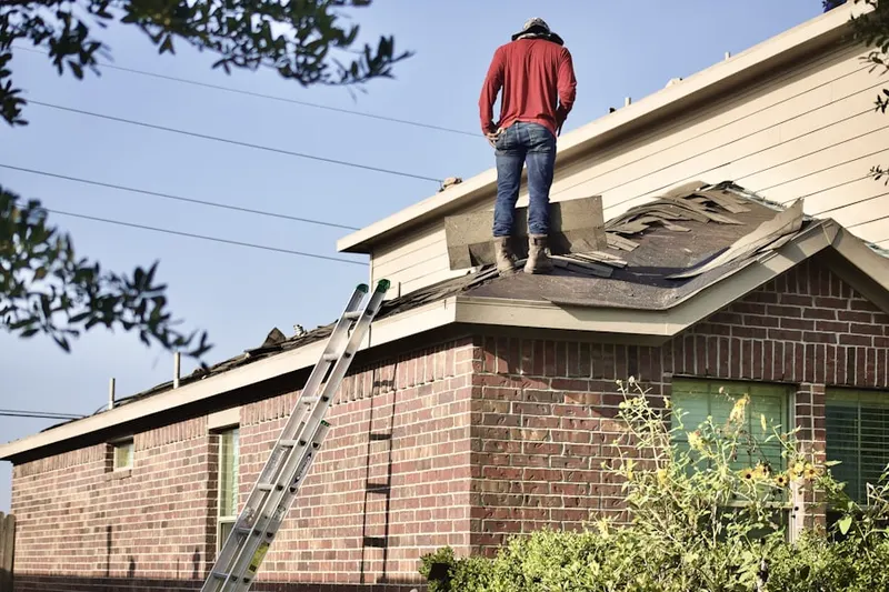 Professional roofer working on a residential roof in Sayville